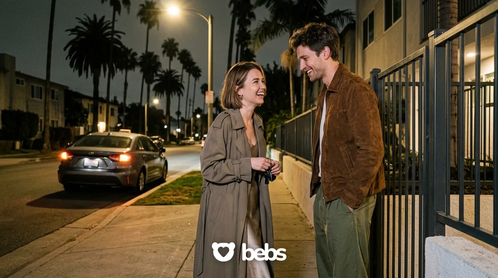 Couple lingering at her gate at night after a first date while their rideshare waits, not wanting to say goodbye